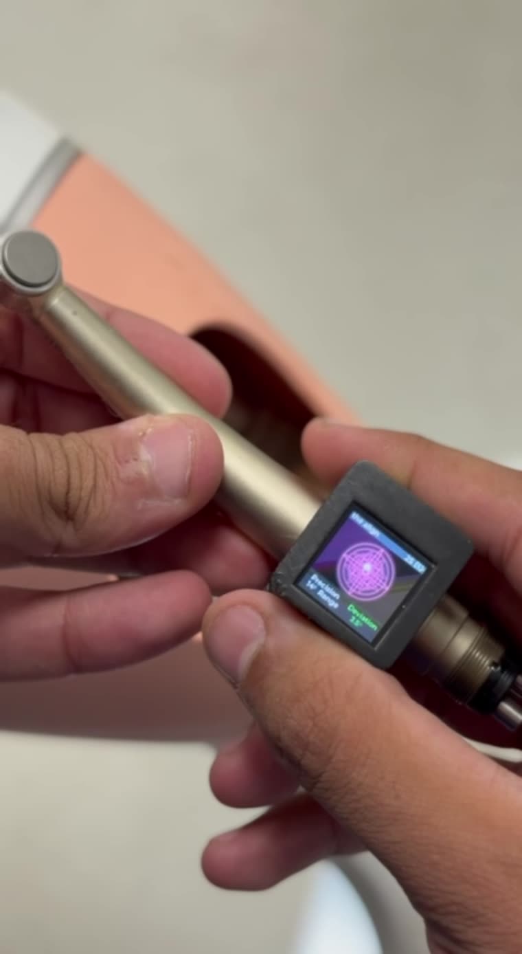 The Align mounted on a dental handpiece, its angle display lit